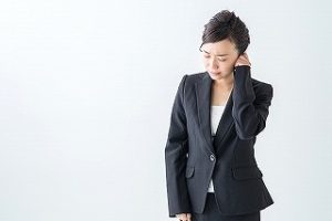 首を押さえて悩んでいる様子